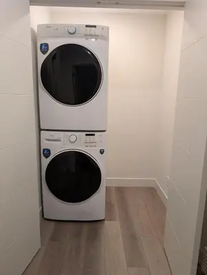 two microwaves stacked on top of each other in a room at 21 Greenwich Common NW Calgary Alberta in Calgary