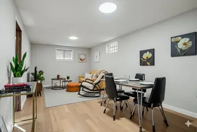 a dining room and living room with a table and chairs at Family Friendly Welcoming Basement Suite in Calgary