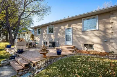 a wooden deck in front of a house at Family Friendly Welcoming Basement Suite in Calgary