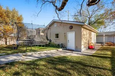 a small white house with a white garage at Family Friendly Welcoming Basement Suite in Calgary