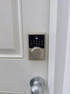 a bathroom door with a control panel on the wall at Modern Comfort West Edmonton in Edmonton