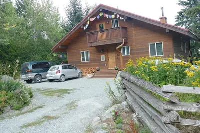 a house with two cars parked in front of it at Pemberton Tree Lodge in Pemberton