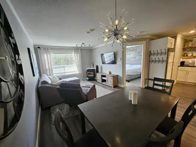 a living room with a table and a dining room at White-Tail Hollow - 309 - 1105 Henry Rd in Courtenay