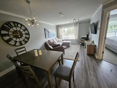 a living room with a dining room table and a couch at White-Tail Hollow - 309 - 1105 Henry Rd in Courtenay