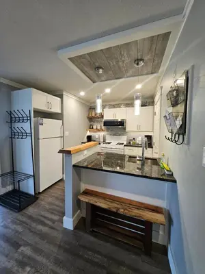 a kitchen with a counter and a refrigerator at White-Tail Hollow - 309 - 1105 Henry Rd in Courtenay