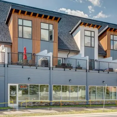 a building with a red fire hydrant on the balcony at Stunning Modern 2BR Unit in Downtown Canmore in Canmore