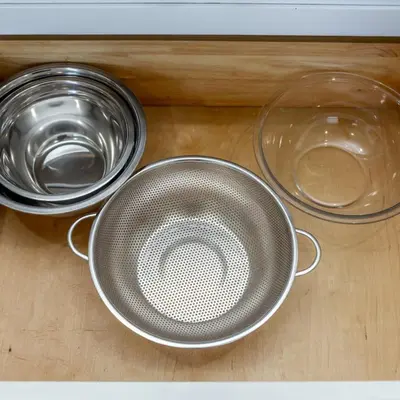 three metal bowls and a glass bowl on a table at BoHo House-Sleeps 17-Garage-3 Kitchens-Fireplace in Edmonton