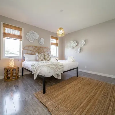 a bedroom with a large bed in a room at BoHo House-Sleeps 17-Garage-3 Kitchens-Fireplace in Edmonton