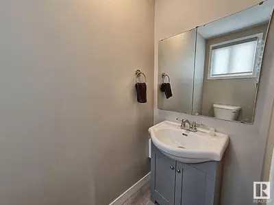 a bathroom with a sink and a mirror at UofA Bike Lane-Train-Bus- Southgate Mall, Cental in Edmonton