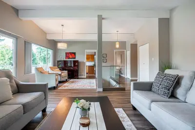a living room with two couches and a table at Serene Nature Retreat in North Vancouver