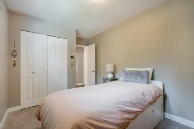 a bedroom with a bed with a blue pillow on it at Serene Nature Retreat in North Vancouver