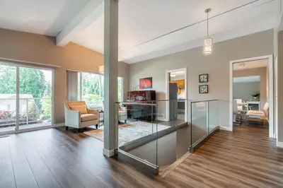 an empty living room with a glass wall at Serene Nature Retreat in North Vancouver
