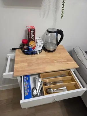 a table with a coffee maker on top of it at Amaville - One BRM Private Suite in West Edmonton in Edmonton