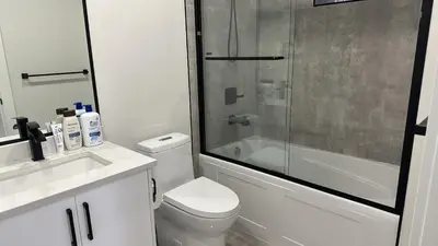 a bathroom with a shower and a toilet and a sink at Metrotown area in Vancouver