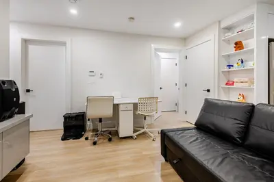 a living room with a couch and a desk at Metrotown area in Vancouver