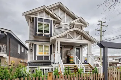 a house with a white fence in front of it at Metrotown area in Vancouver