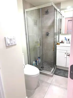 a bathroom with a shower and a toilet at W 20 House in Vancouver