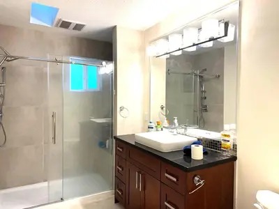 a bathroom with a shower and a sink and a showerspective at W 20 House in Vancouver