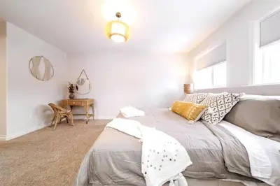 a white bedroom with a bed and a table at Luxe Escape Duo - 8 Beds - Sleeps 22 - 4 Car Garage in Edmonton