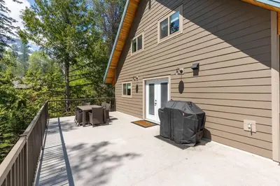 a patio with two stools and a building at True North Chalet by Fernie Central Reservations in Fernie