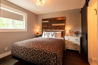 a bedroom with a bed and a window at True North Chalet by Fernie Central Reservations in Fernie