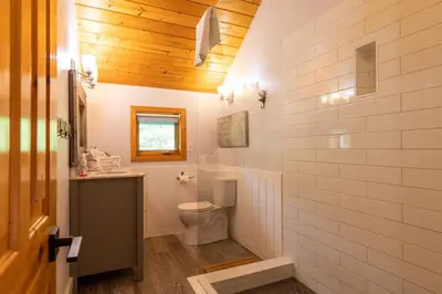 a bathroom with a toilet and a sink at True North Chalet by Fernie Central Reservations in Fernie