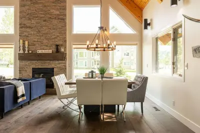 a dining room with a table and chairs and a fireplace at True North Chalet by Fernie Central Reservations in Fernie