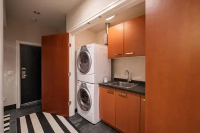 a kitchen with a washing machine and a sink at Fitzsimmons Walk 15 by Outpost Whistler in Whistler