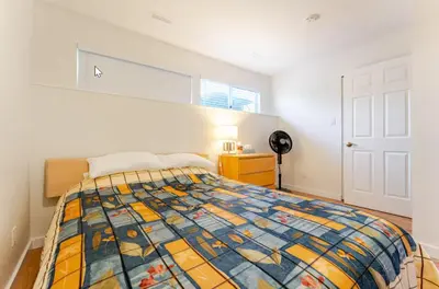 a bedroom with a bed with a colorful quilt at Spacious & Cozy 1 Bedroom Suite in North Vancouver in North Vancouver