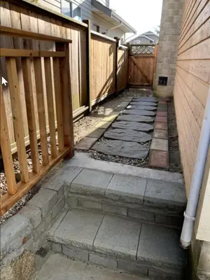 an empty patio with a wooden fence and a gate at Spacious & Cozy 1 Bedroom Suite in North Vancouver in North Vancouver