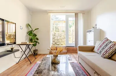 a living room with a couch and a window at Spacious & Cozy 1 Bedroom Suite in North Vancouver in North Vancouver