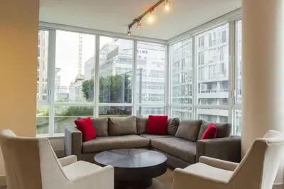 a living room with a couch and chairs and windows at Corporate Stays Capitol Residences 1 Bedroom in Vancouver