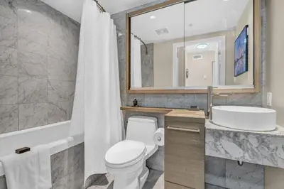 a bathroom with a toilet and a sink and a mirror at Corporate Stays Capitol Residences 1 Bedroom in Vancouver