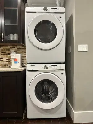a washing machine and a dryer in a kitchen at Bright New 2BR Suite Near YVR in Vancouver
