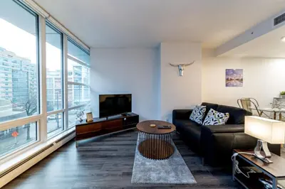 a living room with a couch and a tv at Corporate Stays Tate 1 Bedroom in Vancouver