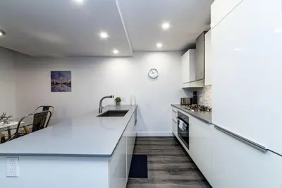 a kitchen with white cabinets and a counter top at Corporate Stays Tate 1 Bedroom in Vancouver