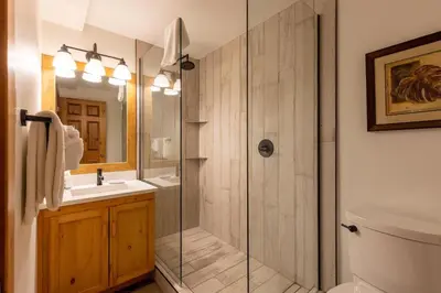 a bathroom with a shower and a sink at Black Diamond Chalet by Fernie Central Reservations in Fernie