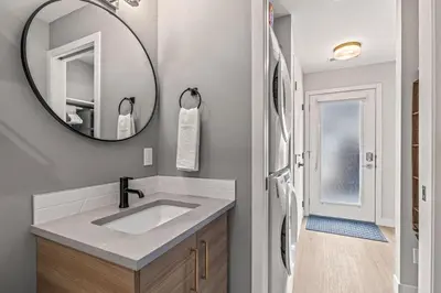 a bathroom with a sink and a mirror at Chick and Cozy Haven near Banff with Hot tub and Pool in Canmore