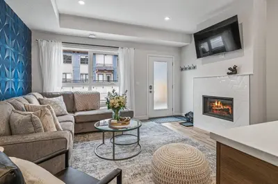a living room with a couch and a fireplace at Classic Modern 4BR Nearby DT Hot tub and Pool in Canmore