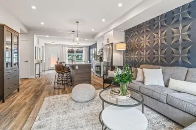 a living room with a couch and a table at Classic Modern 4BR Nearby DT Hot tub and Pool in Canmore
