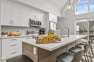 a kitchen with a counter with a bowl of bananas on it at Mountain Modern 2BR Townhome with Stunning View in Canmore