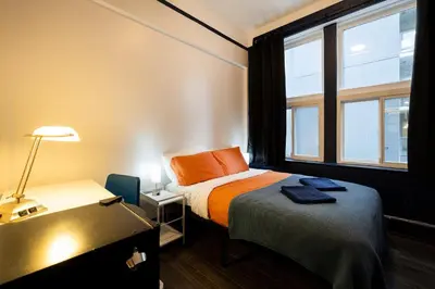 a small room with a bed and a window at The Guesthouse Vancouver Downtown in Vancouver