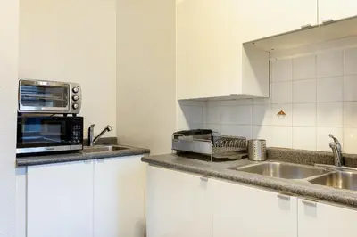 a kitchen with a microwave and a sink at The Guesthouse Vancouver Downtown in Vancouver