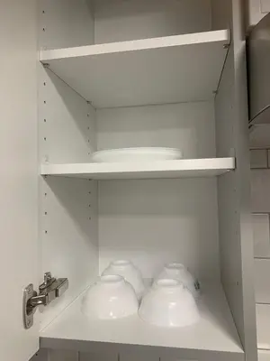 a cupboard with three white bowls and a sink at Modern and cozy stay-2 Bedroom Basement in Edmonton