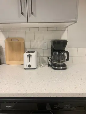 a kitchen counter with a coffee maker and a toaster at Modern and cozy stay-2 Bedroom Basement in Edmonton