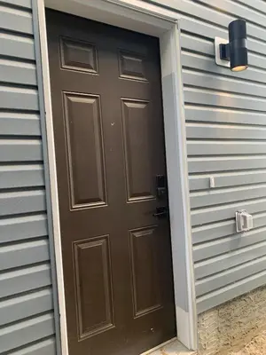a brown door on the side of a house at Modern and cozy stay-2 Bedroom Basement in Edmonton
