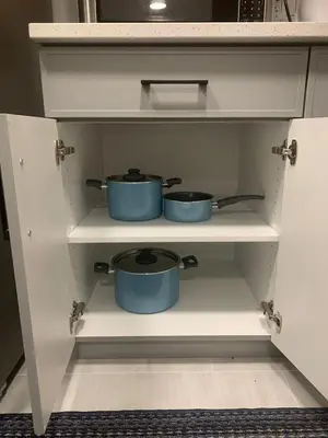 two pots sitting on a shelf in a kitchen at Modern and cozy stay-2 Bedroom Basement in Edmonton