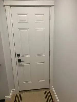 a white door in a room with a hallway at Modern and cozy stay-2 Bedroom Basement in Edmonton