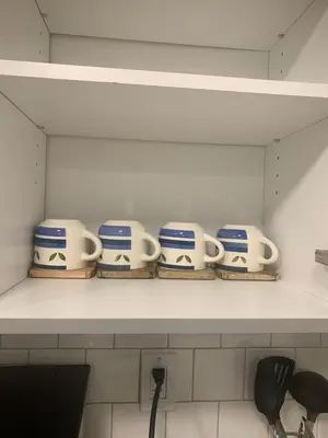 a shelf with four blue and white cups on it at Modern and cozy stay-2 Bedroom Basement in Edmonton