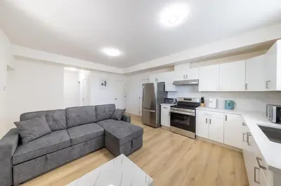a living room with a couch and a kitchen at Tranquil 2-Bedroom Basement Suite Relaxing Stay in Chilliwack